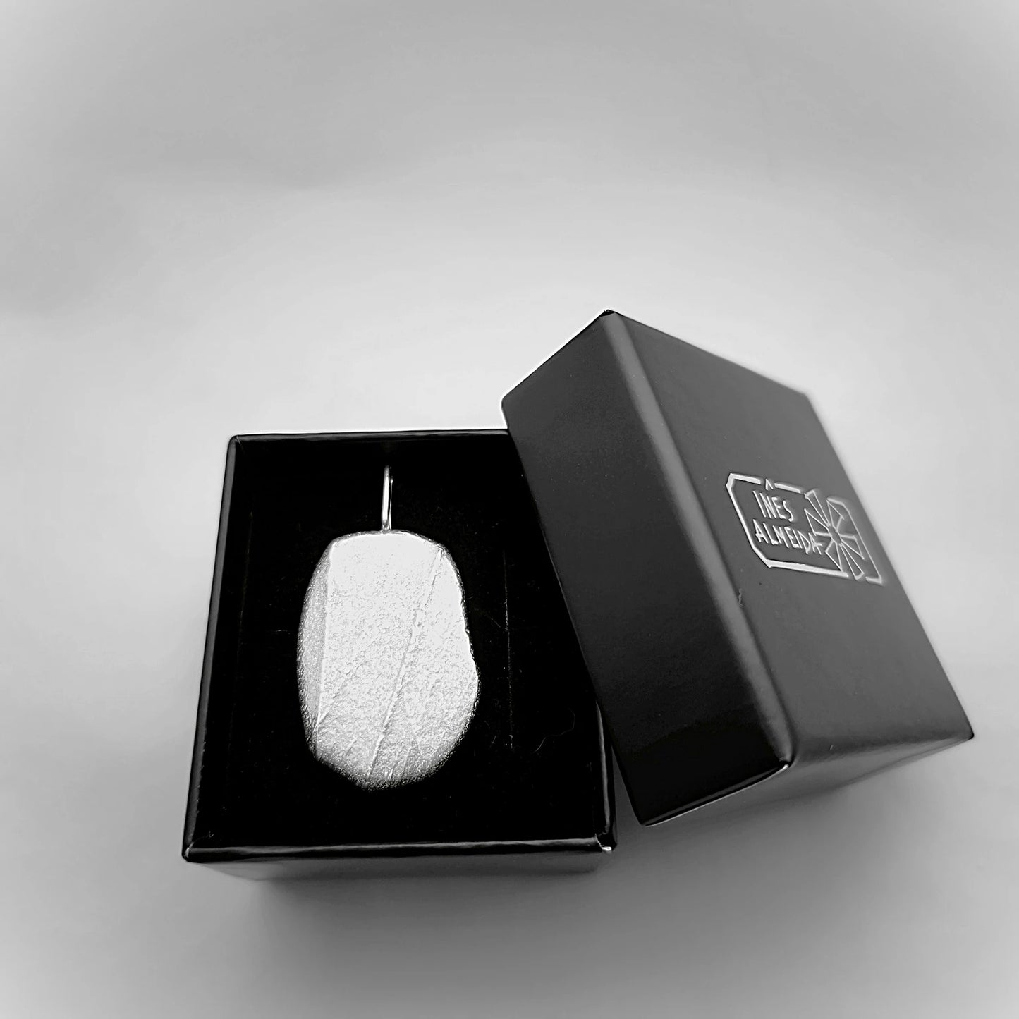 925 sterling silver pendant with the texture from a pebble in a jewellery back box. Design by Inês Almeida