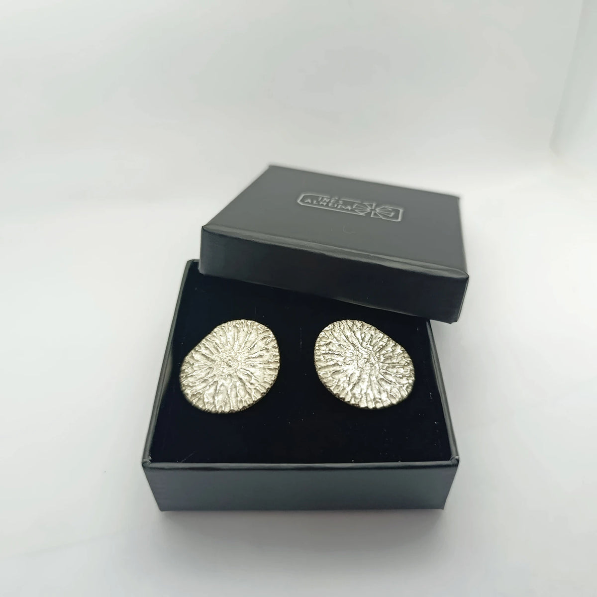 925 sterling silver earrings with the texture from a dolphin spine bone, in a jewellery box. Design by Inês Almeida,