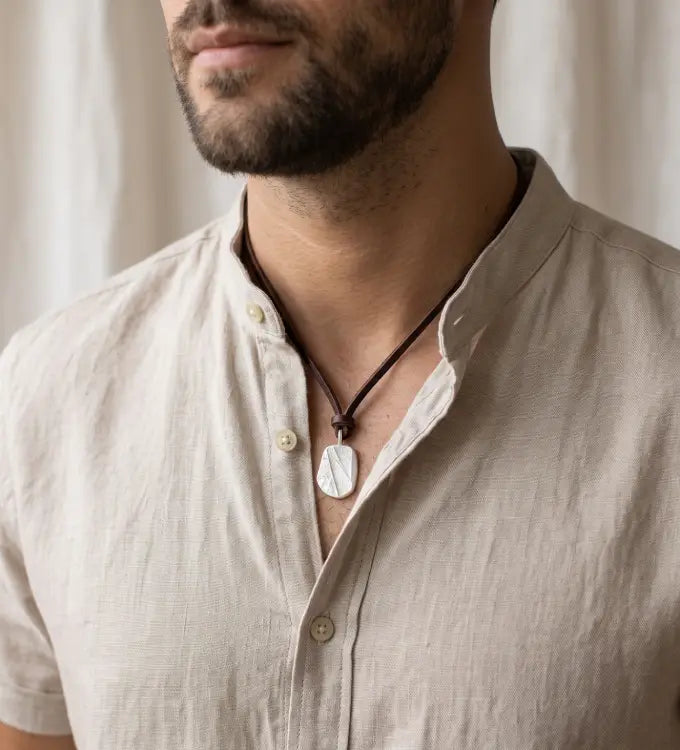 Mean wearing a 925 sterling silver oxidised pendant with the texture from a conch shell. Design by Inês Almeida