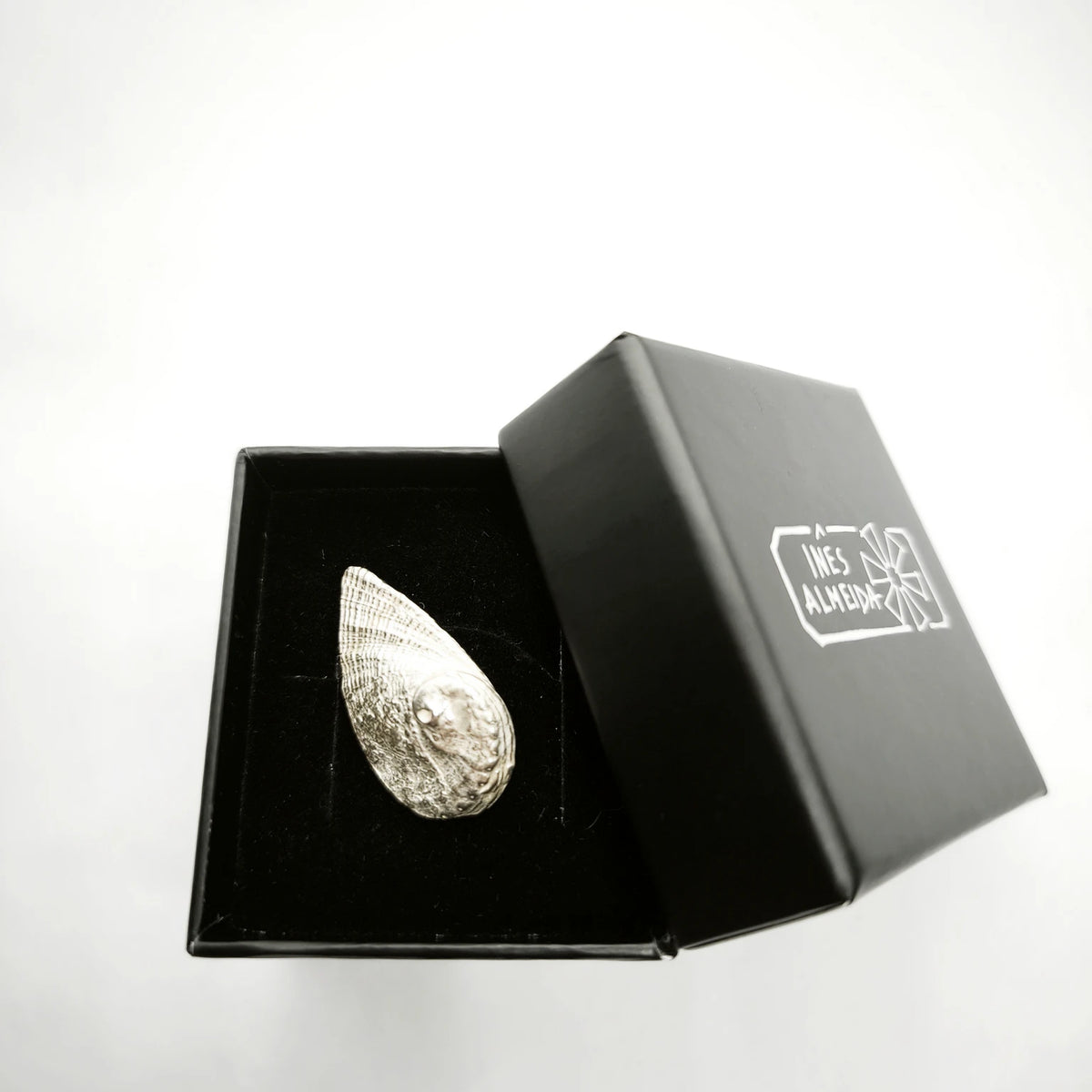 925 sterling silver pendent with the texture from a Fragment of an abalone in a jewellery black box. Design by Inês Almeida
