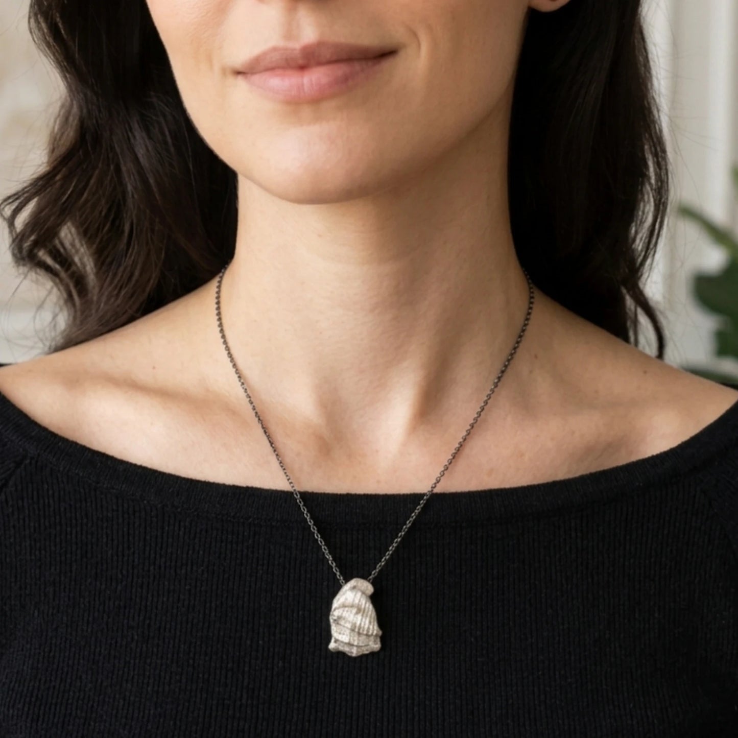 Woman wearing a 925 sterling silver pendant with the texture from a conch shell. Design by Inês Almeida