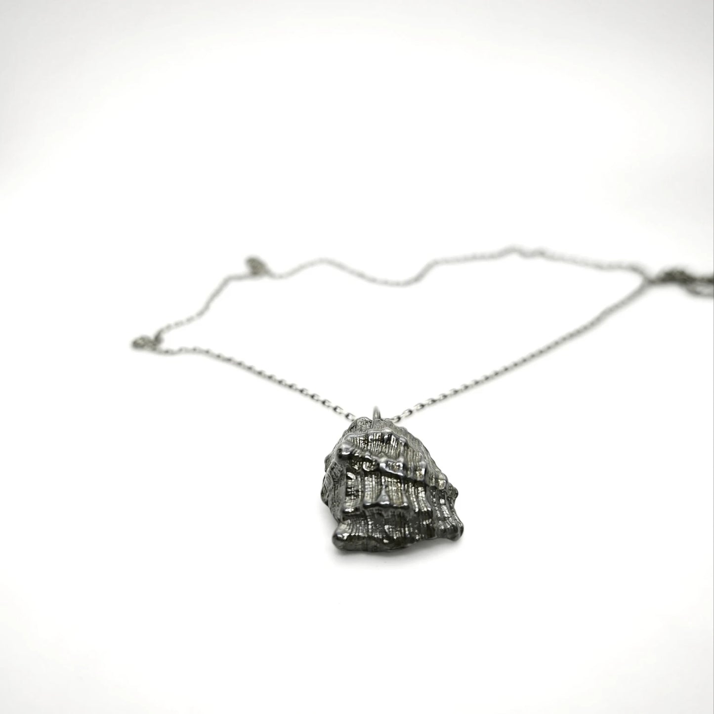 925 sterling silver oxidised pendant with the texture from a conch shell. Design by Inês Almeida