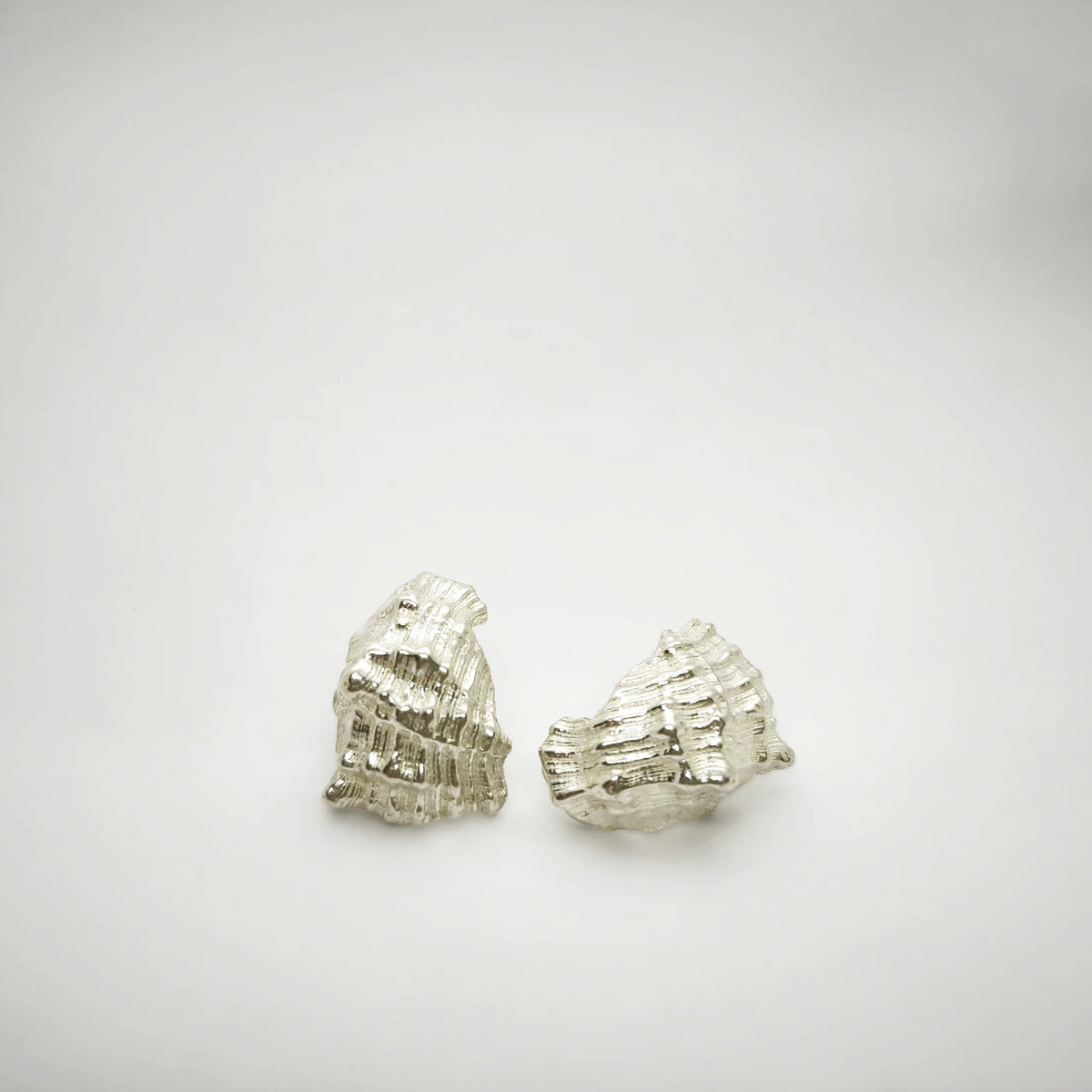 925 sterling silver earrings with the texture from a conch shell. Design by Inês Almeida