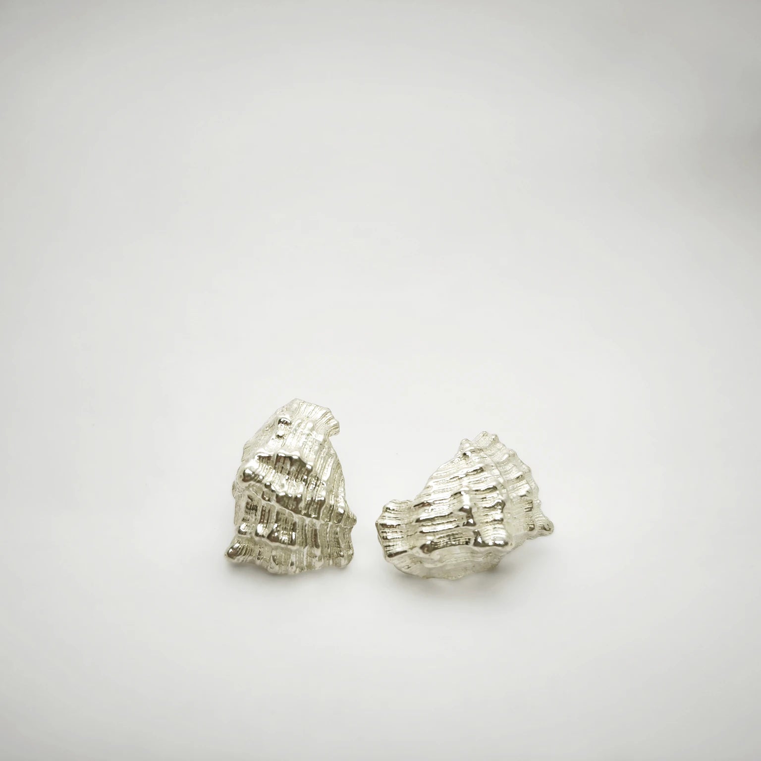 925 sterling silver earrings with the texture from a conch shell. Design by Inês Almeida