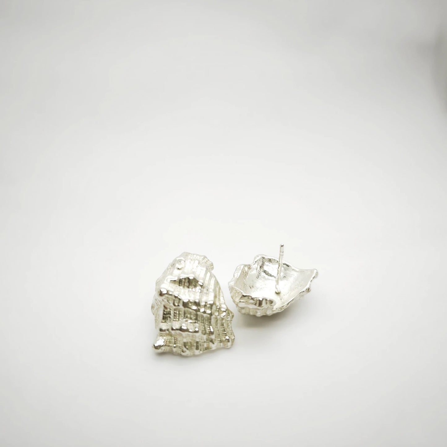 925 sterling silver earrings with the texture from a conch shell. Design by Inês Almeida