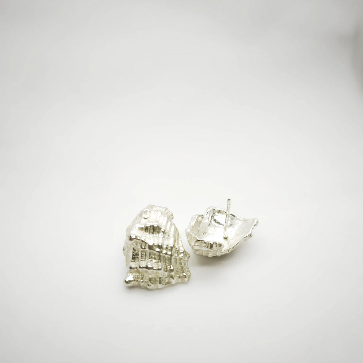 925 sterling silver earrings with the texture from a conch shell. Design by Inês Almeida
