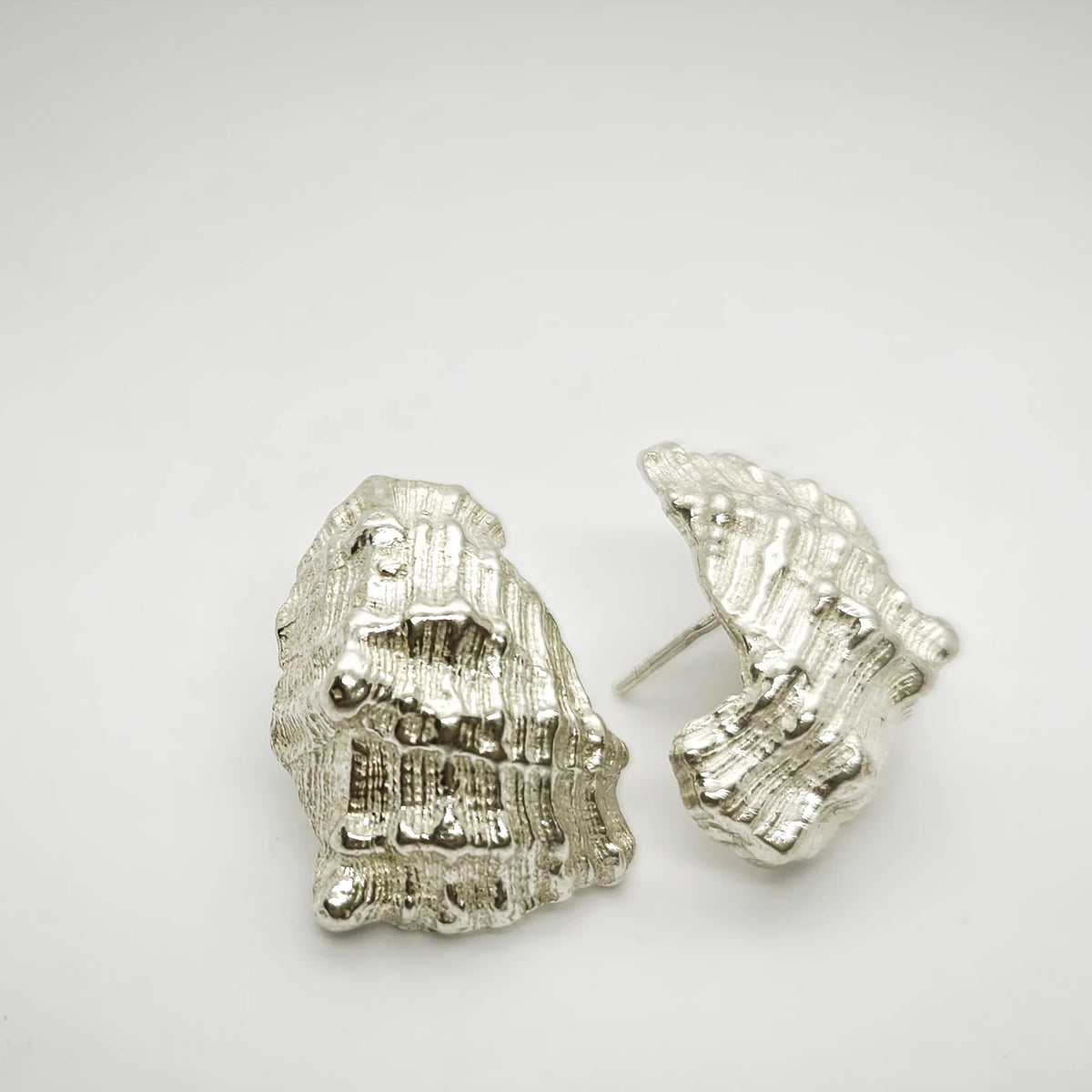 925 sterling silver earrings with the texture from a conch shell. Design by Inês Almeida