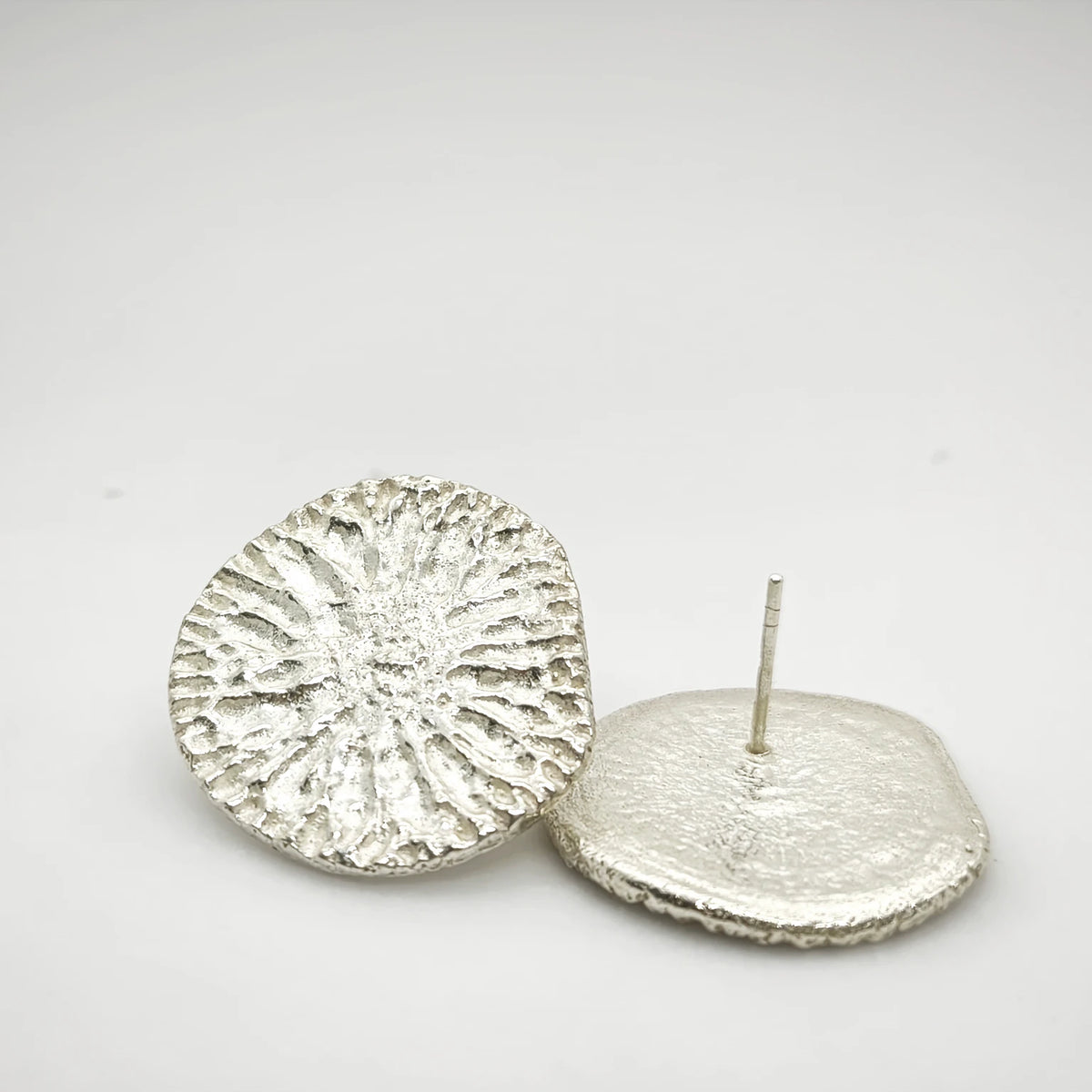 925 sterling silver earrings with the texture from a dolphin spine bone. Design by Inês Almeida