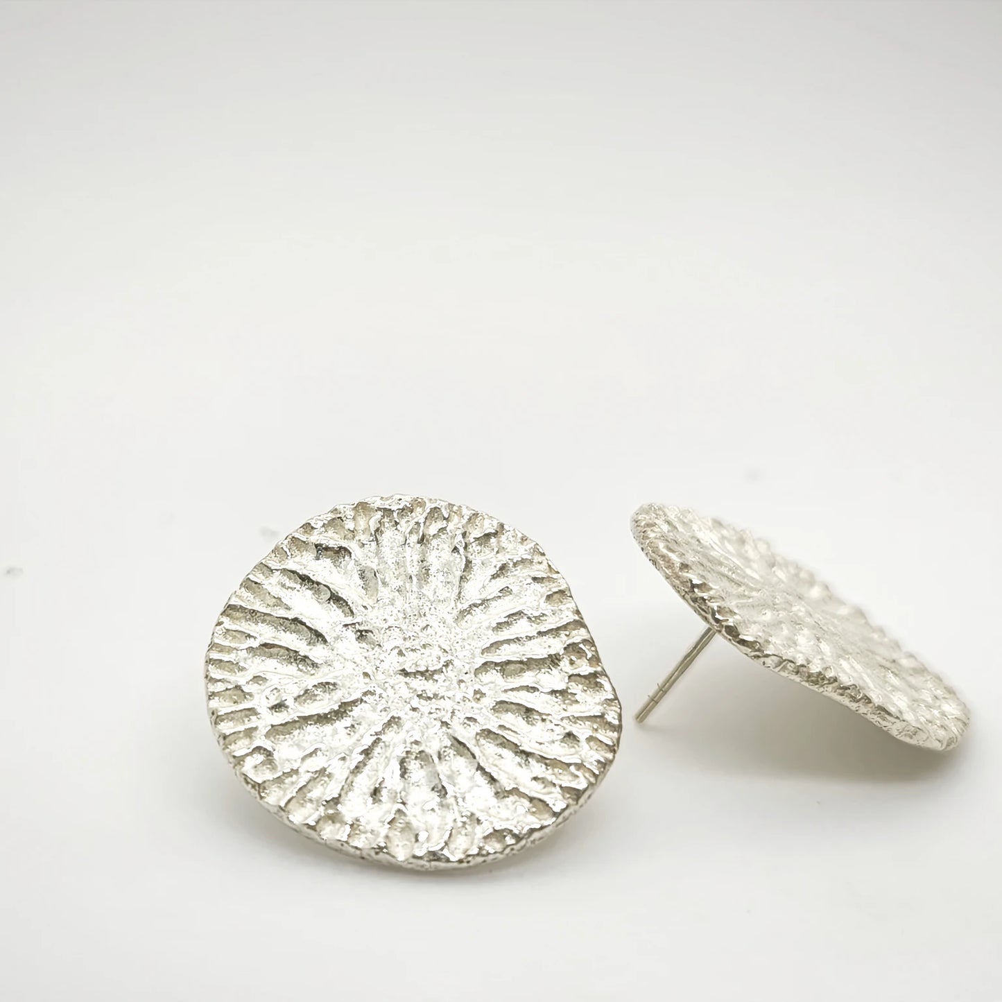 925 sterling silver earrings with the texture from a dolphin spine bone. Design by Inês Almeida