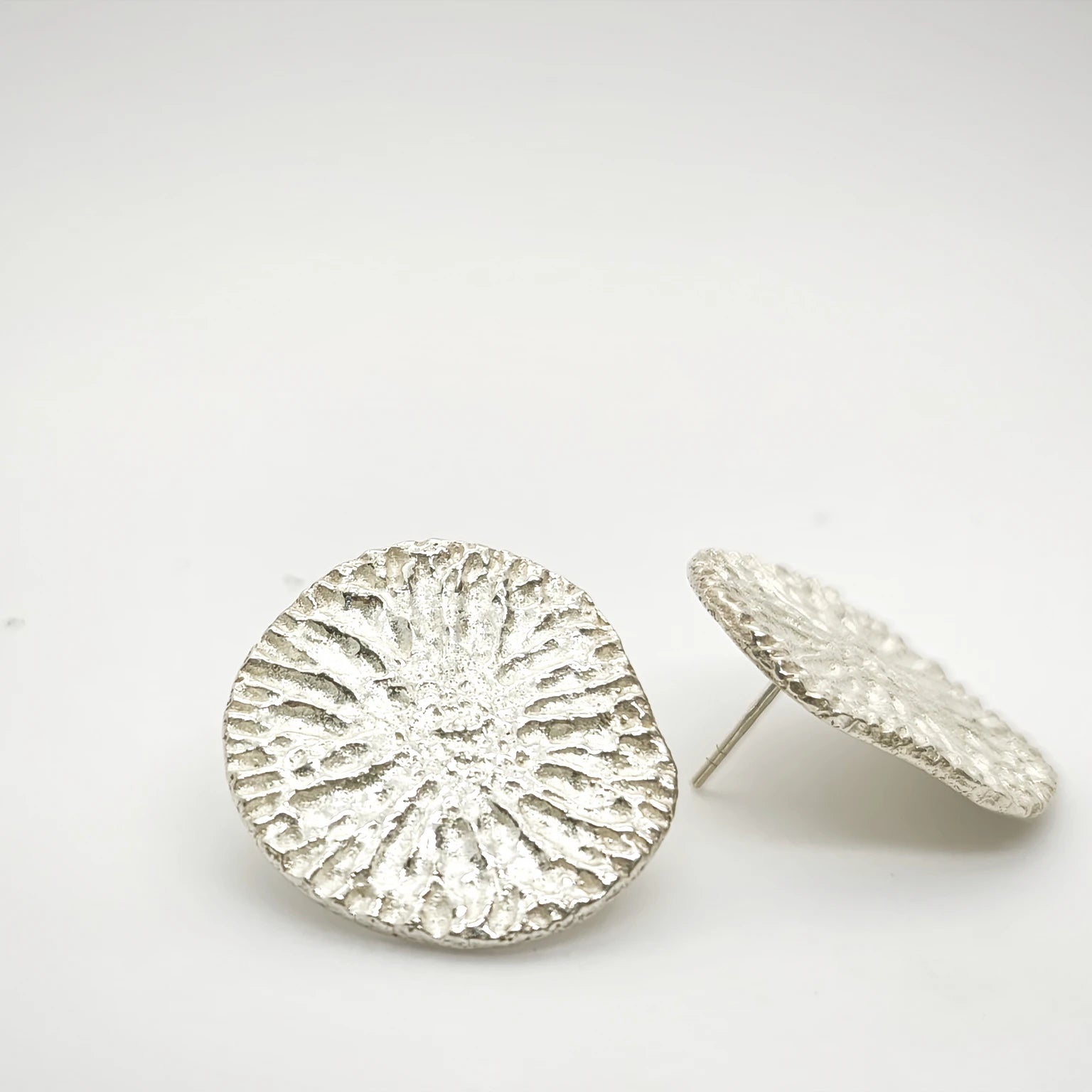925 sterling silver earrings with the texture from a dolphin spine bone. Design by Inês Almeida