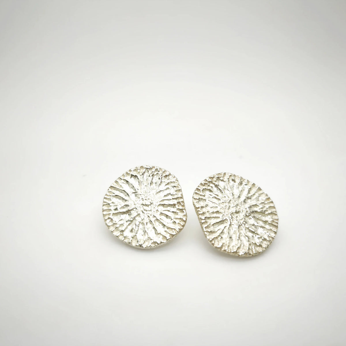 925 sterling silver earrings with the texture from a dolphin spine bone. Design by Inês Almeida