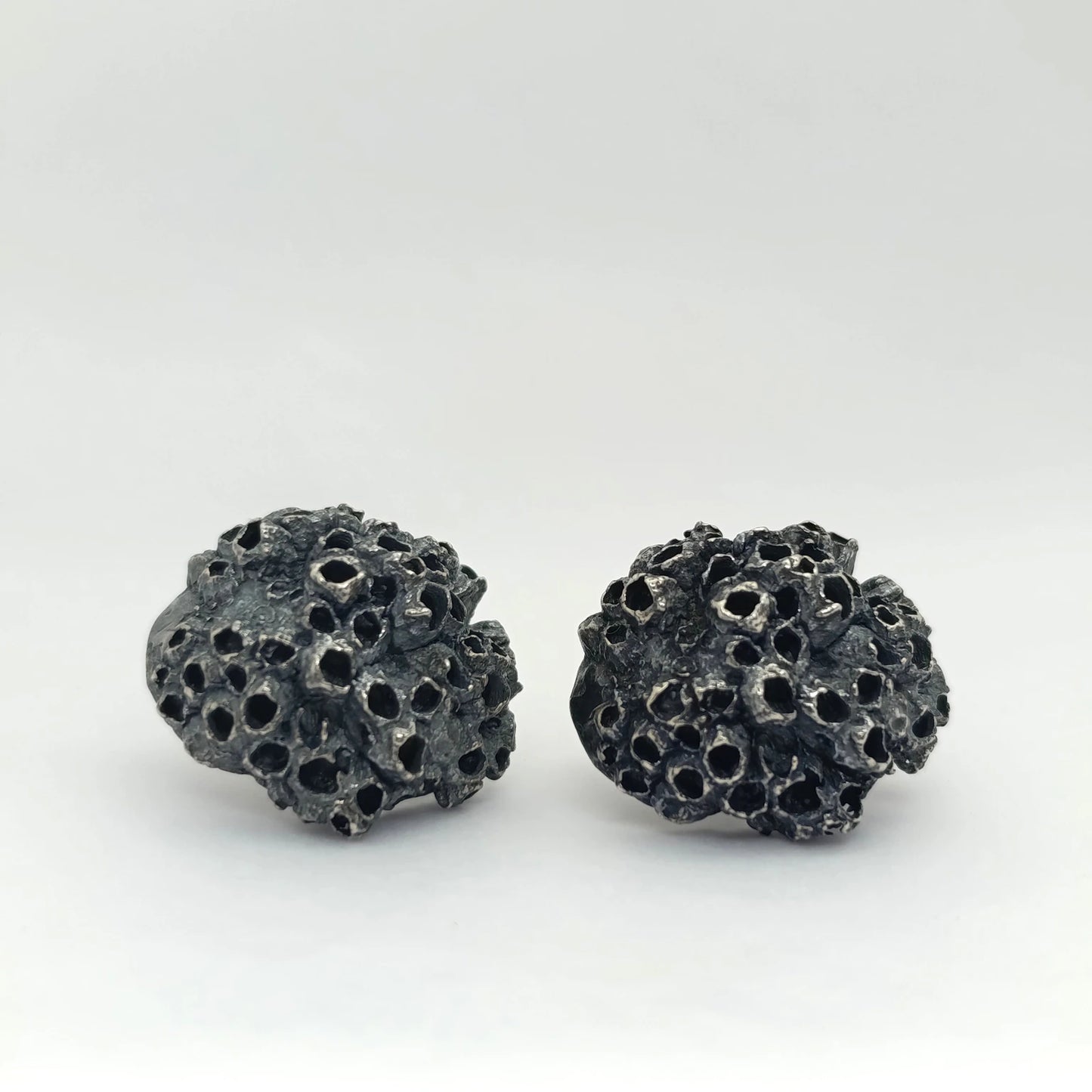 Handcrafted 925 sterling oxidized silver earrings with organic texture inspired by marine barnacles. Piece by Inês Almeida Jewellery
