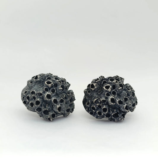 Handcrafted 925 sterling oxidized silver earrings with organic texture inspired by marine barnacles. Piece by Inês Almeida Jewellery