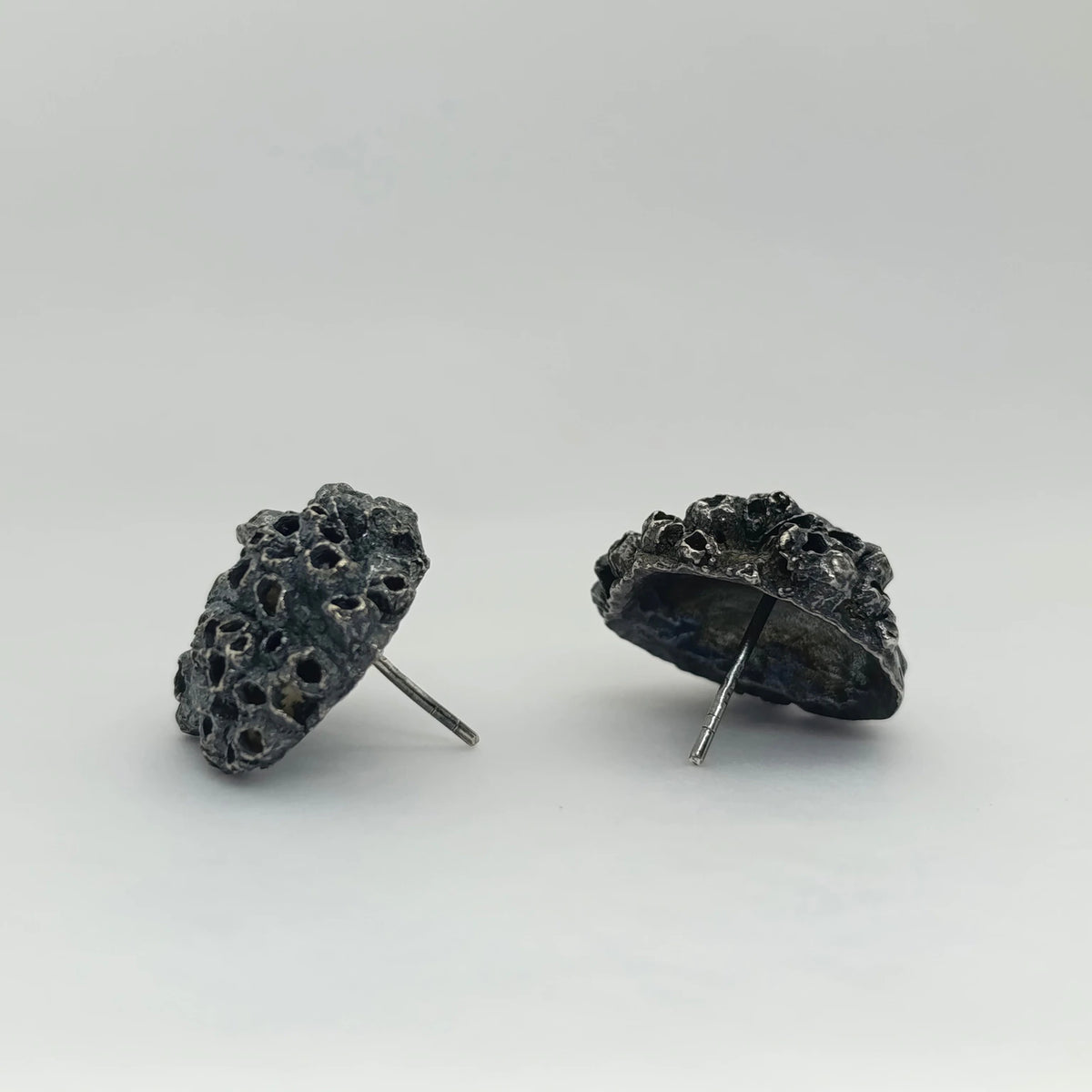 Handcrafted 925 sterling oxidized silver earrings with organic texture inspired by marine barnacles. Piece by Inês Almeida Jewellery