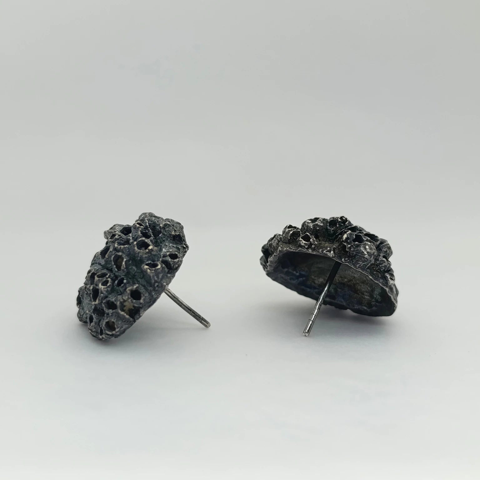 Handcrafted 925 sterling oxidized silver earrings with organic texture inspired by marine barnacles. Piece by Inês Almeida Jewellery