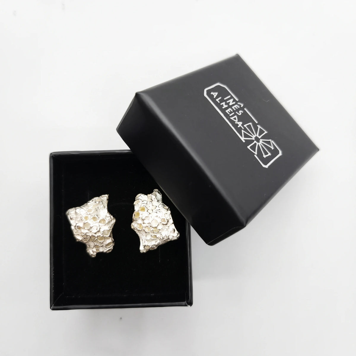 925 sterling silver earrings with the texture from a coraline in a black jewellery box. Design by Inês Almeida