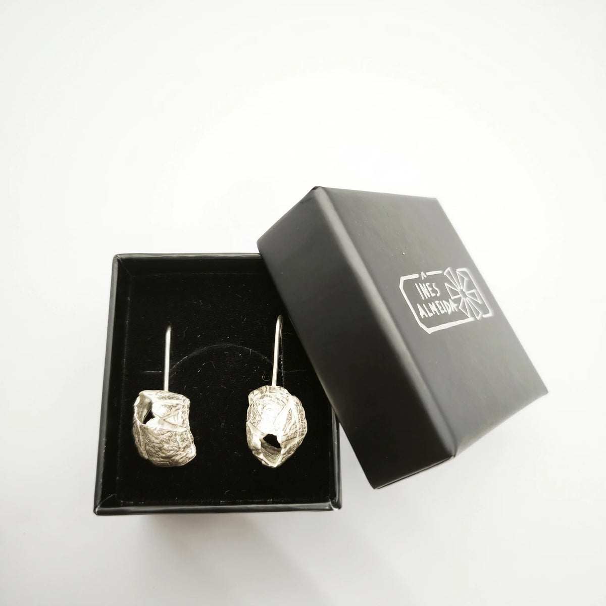 925 sterling silver earrings with the texture from a barnacle in a jewellery black box. Design by Inês Almeida