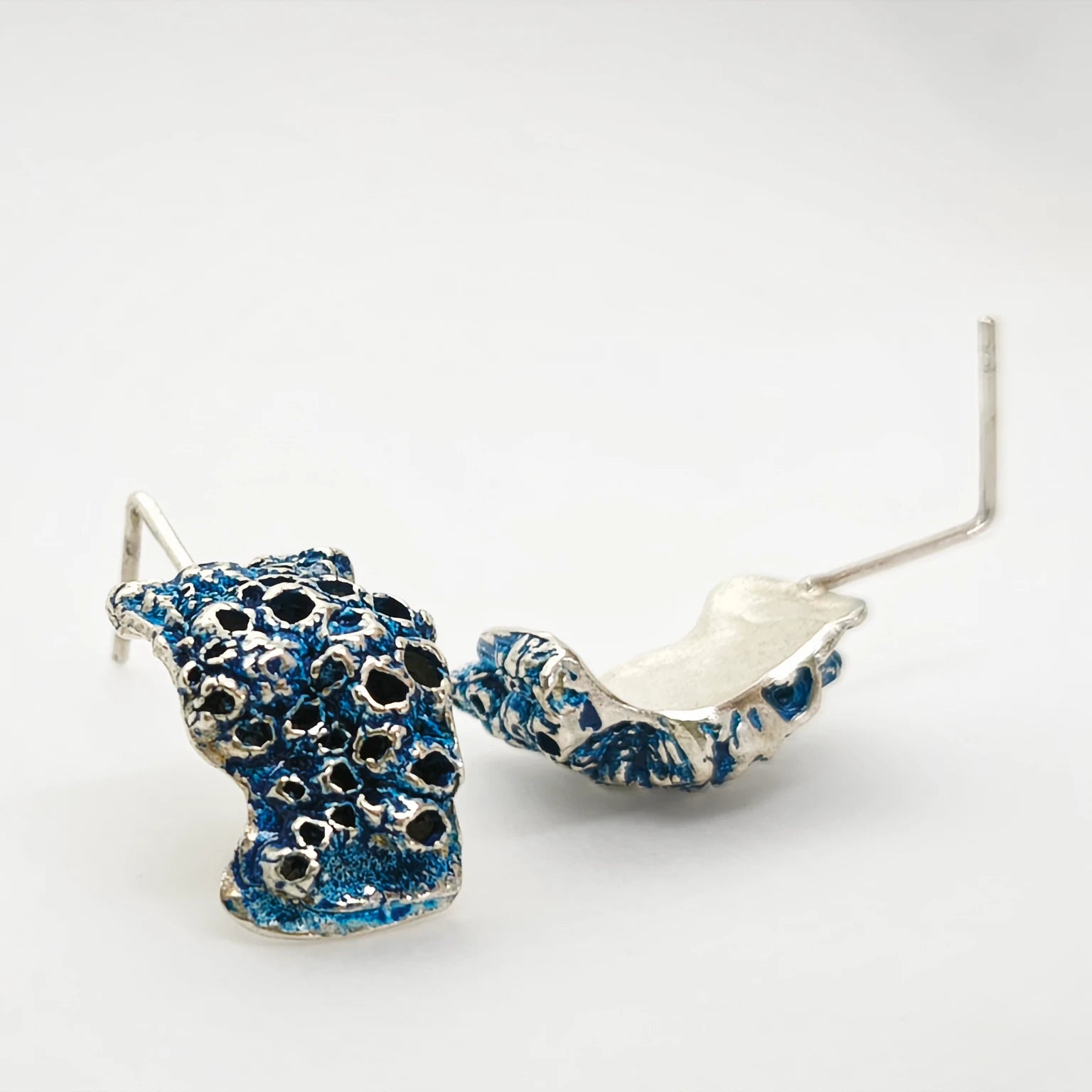 925 sterling silver earrings with the texture from a barnacle painted with blue. Design by Inês Almeida