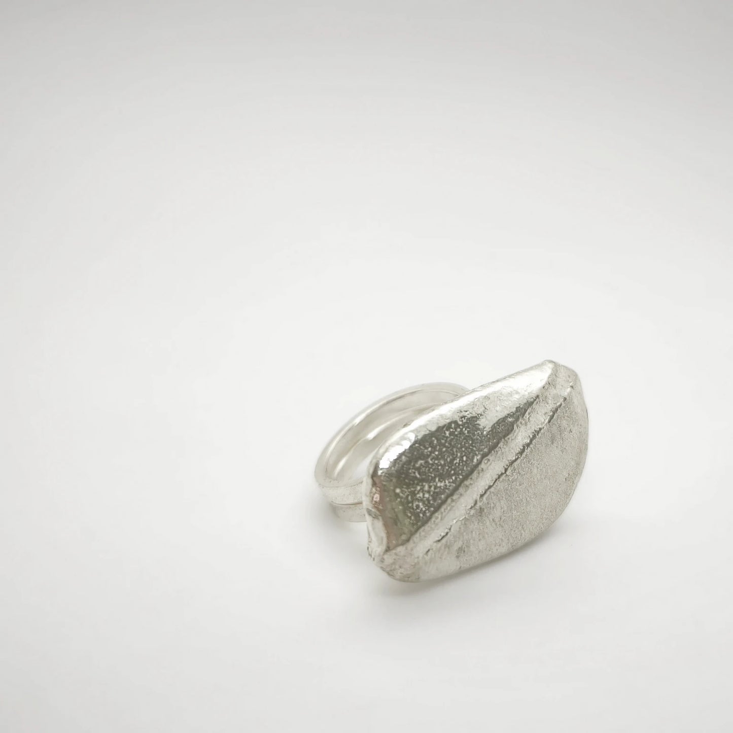 925 sterling silver ring with the texture from a pebble. Design by Inês Almeida