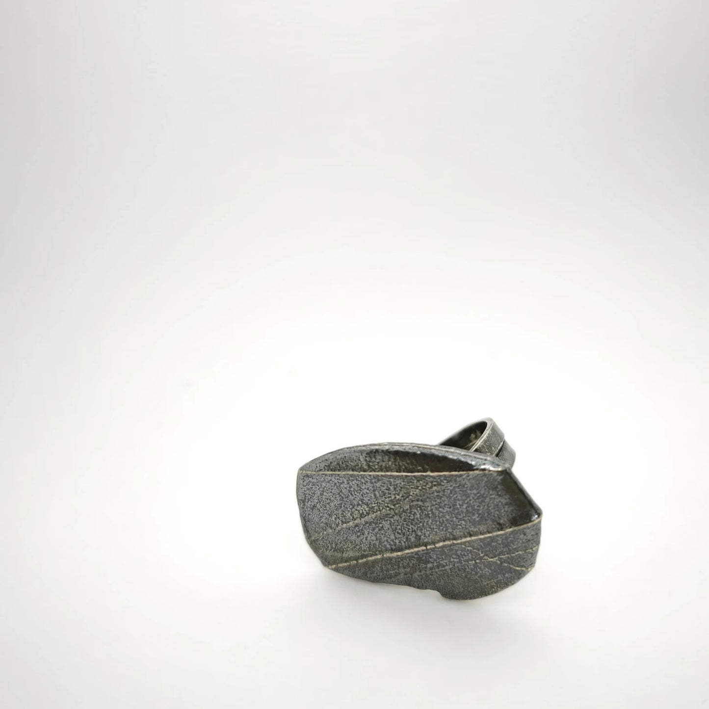 925 sterling silver oxidised ring with the texture from small pebble. Design by Inês Almeida