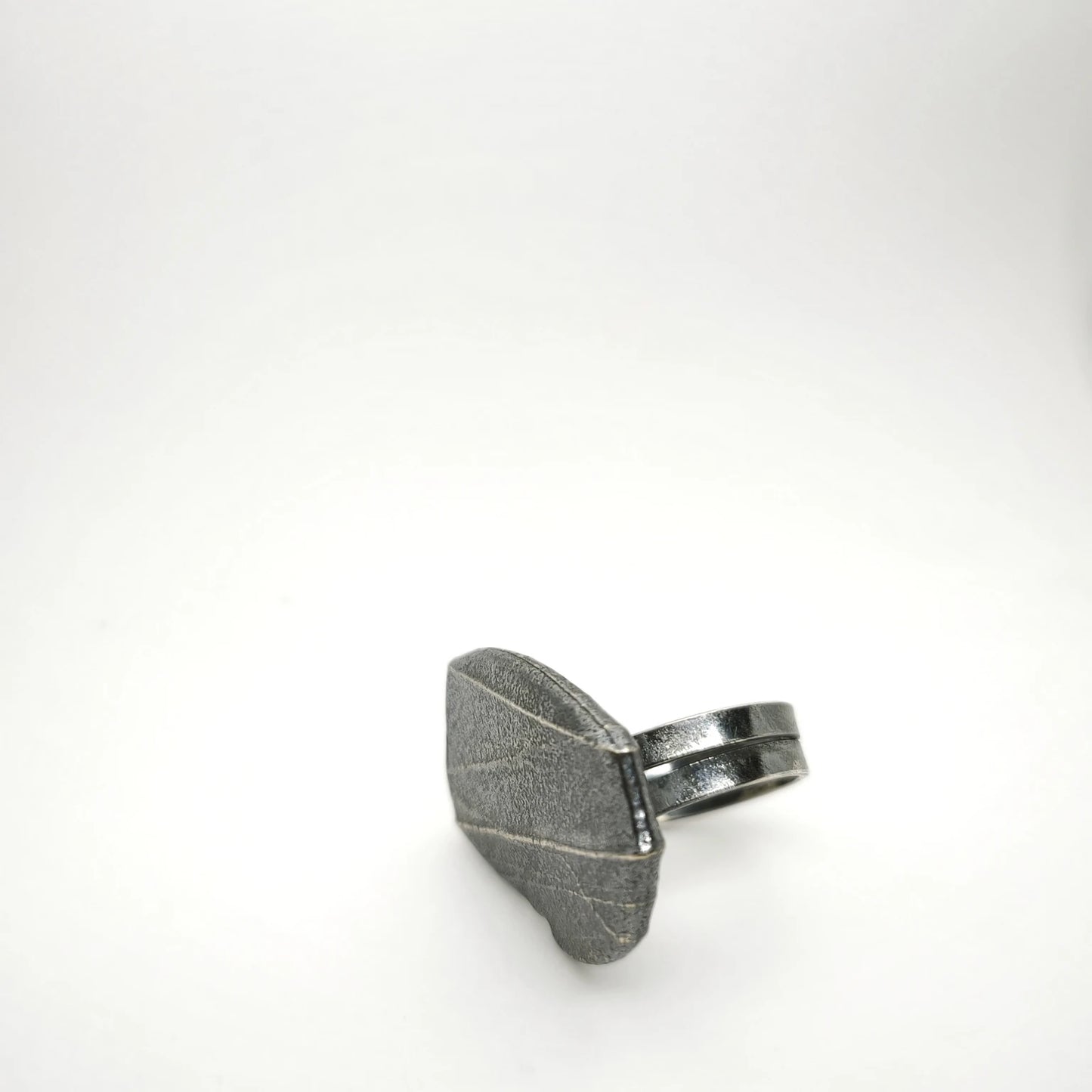 925 sterling silver oxidised ring with the texture from small pebble. Design by Inês Almeida