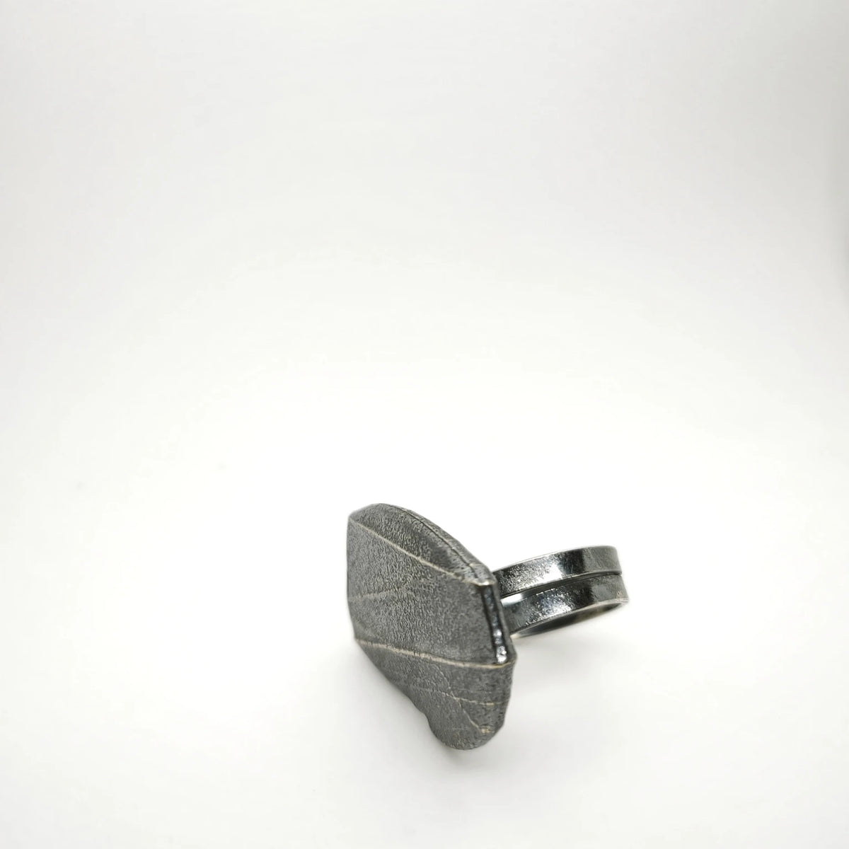 925 sterling silver oxidised ring with the texture from small pebble. Design by Inês Almeida