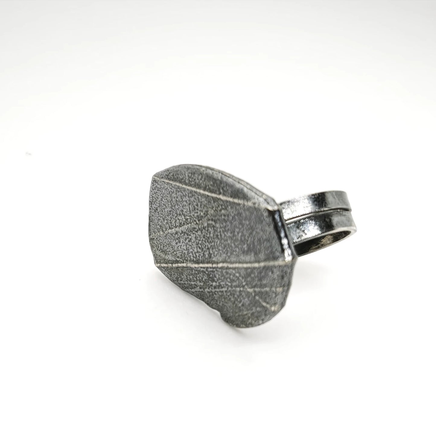 925 sterling silver oxidised ring with the texture from small pebble. Design by Inês Almeida