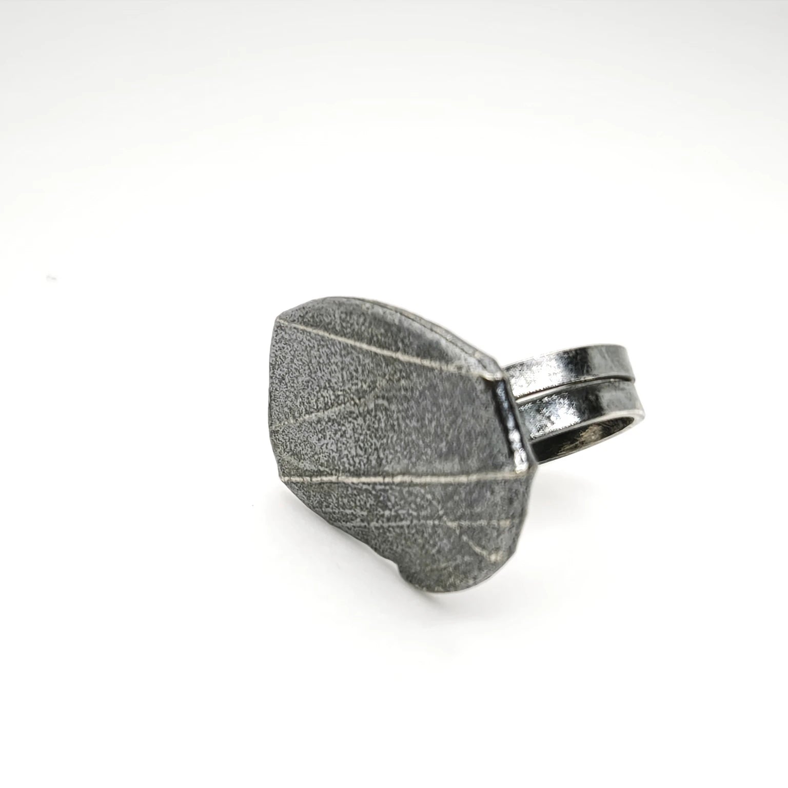925 sterling silver oxidised ring with the texture from small pebble. Design by Inês Almeida