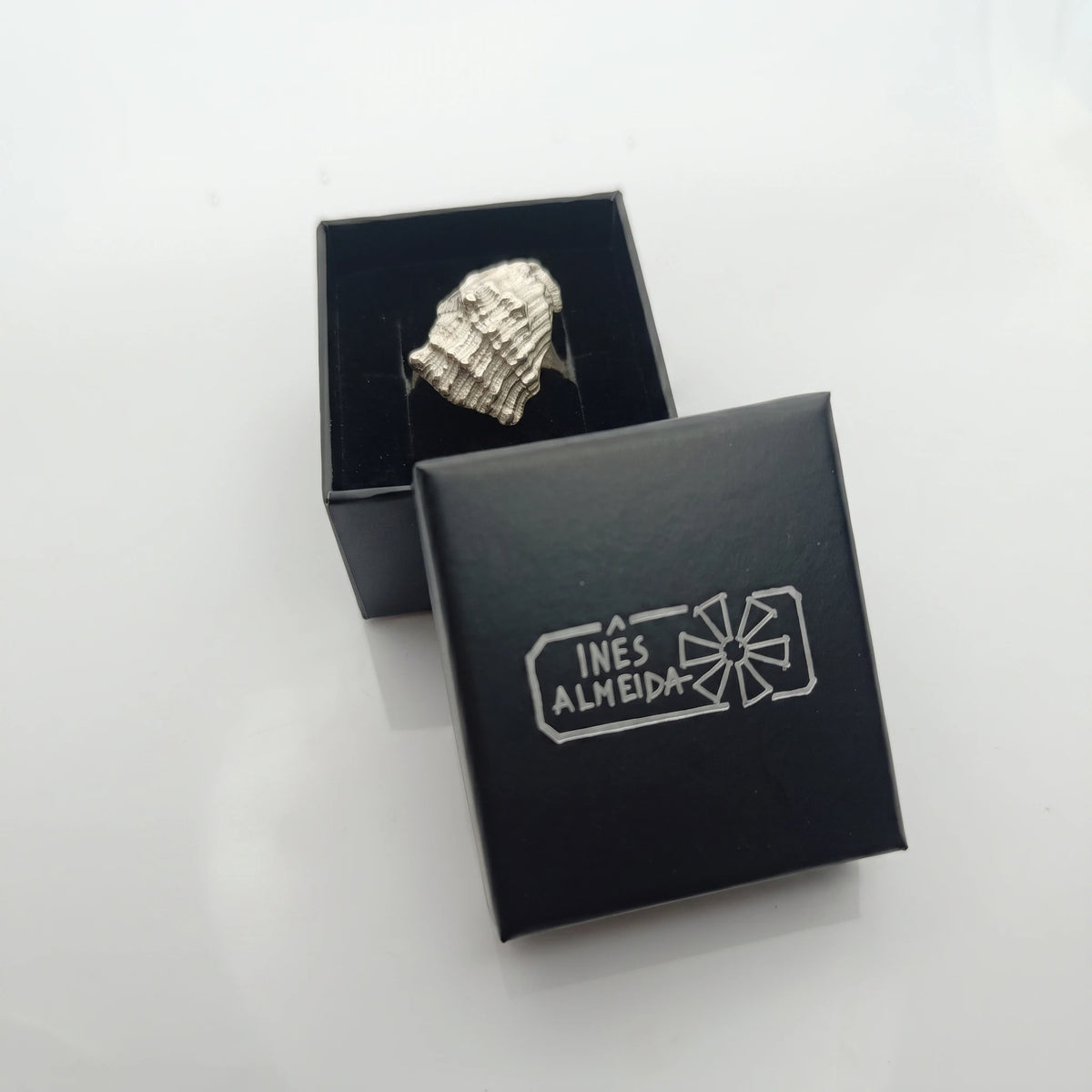925 sterling silver ring with the texture from a conch shell in a jewellery back box. Design by Inês Almeida