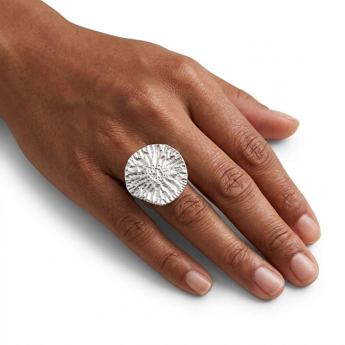 Woman wearing a 925 sterling silver ring with the texture from a dolphin bone. Design by Inês Almeida