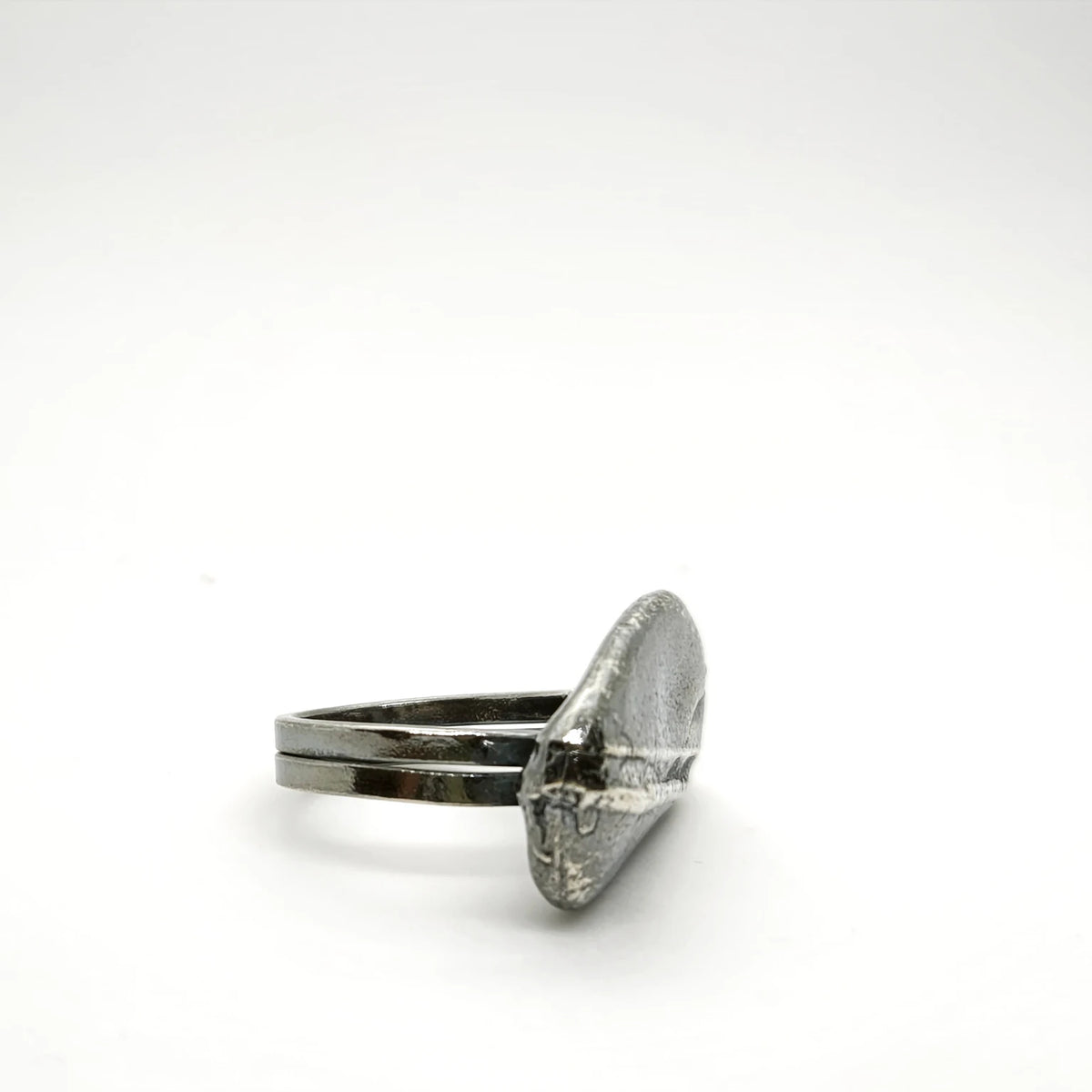 925 sterling silver oxidised ring with the texture from small pebble. Design by Inês Almeida