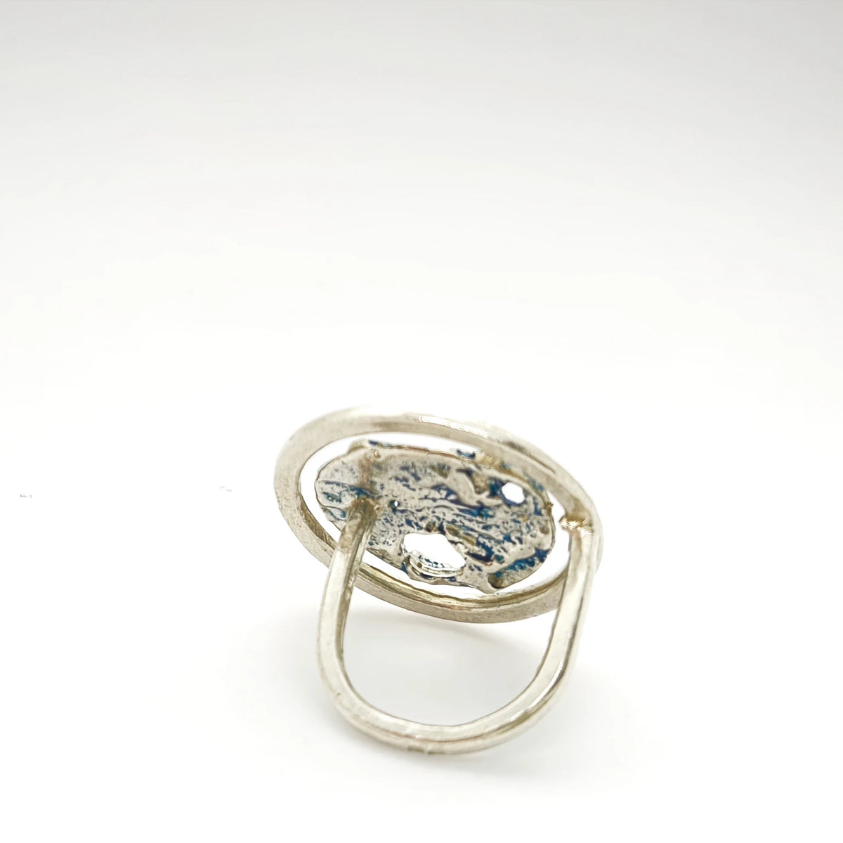 925 sterling silver ring with the texture from a shell painted with blue. Design by Inês Almeida
