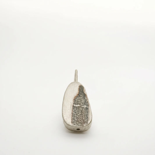 Sterling silver drop earring featuring a black bottle motif, front view, by Inês Almeida.