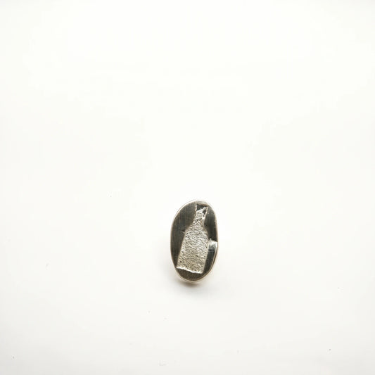 Sterling silver earring featuring a bottle motif, front view, by Inês Almeida.