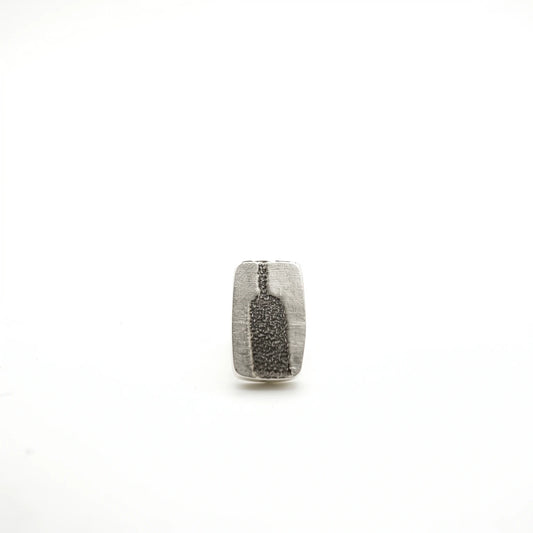 Sterling silver earrings featuring a bottle motif, front view, by Inês Almeida.