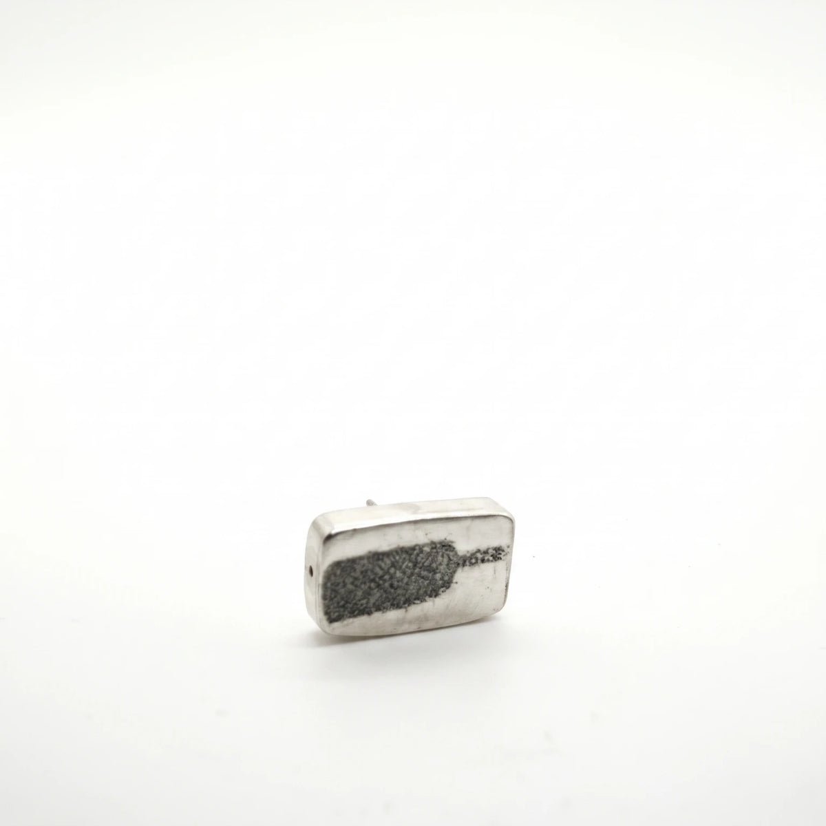 Sterling silver earrings featuring a bottle motif, front view, by Inês Almeida.