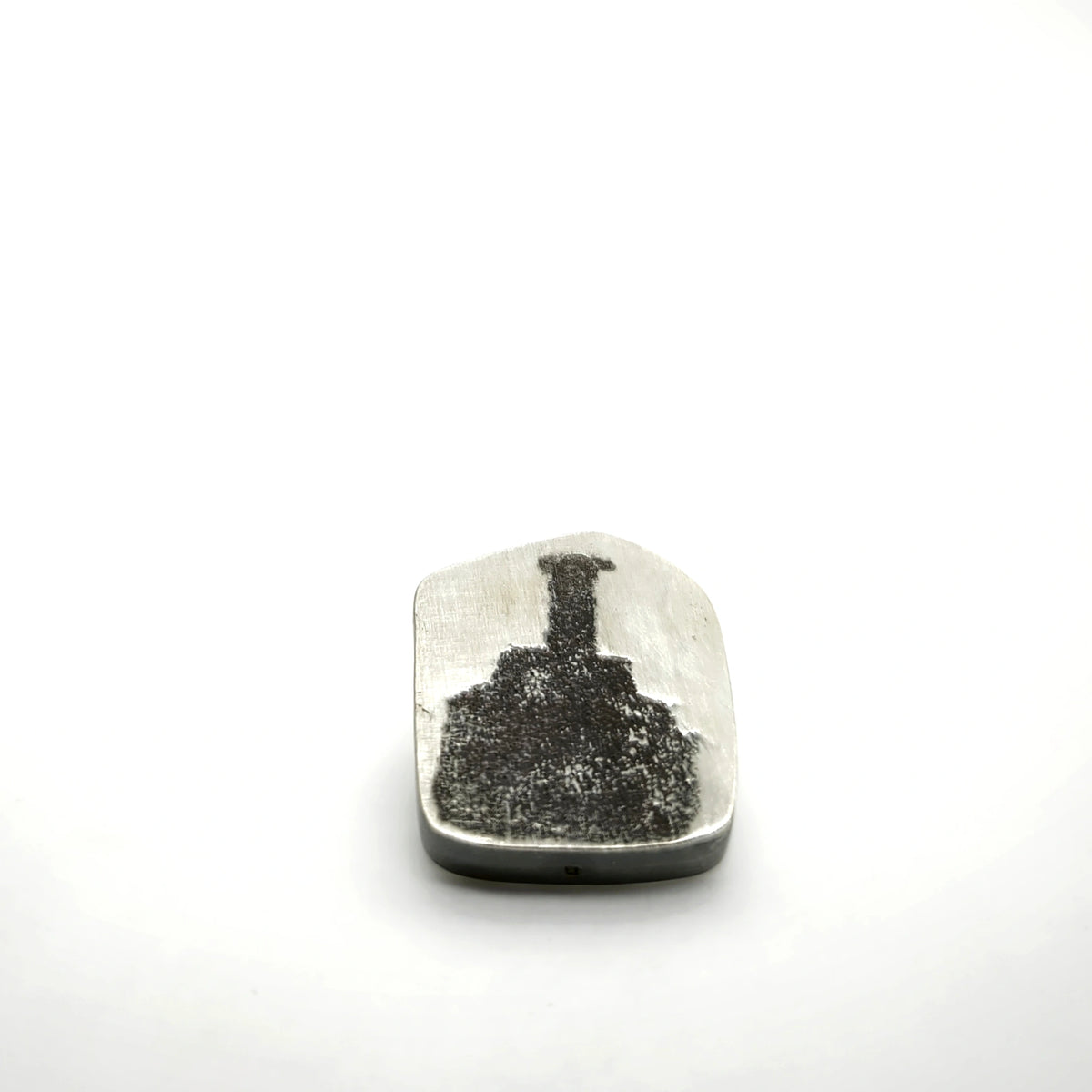Sterling silver pin featuring a bottle motif, front view.