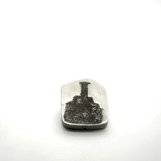 Sterling silver pin featuring a bottle motif, front view.