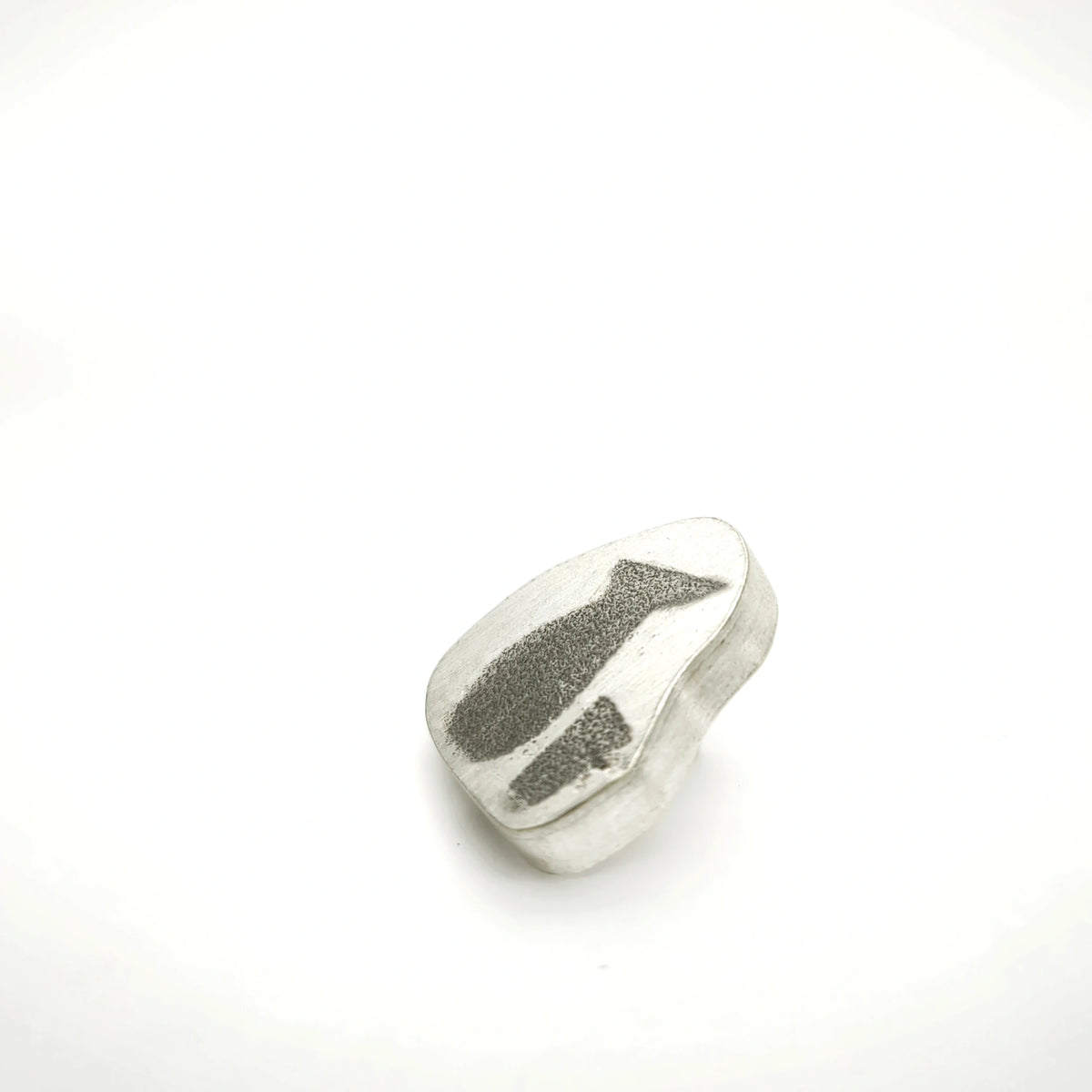 Angled view of a sterling silver pin featuring a jug and glass.