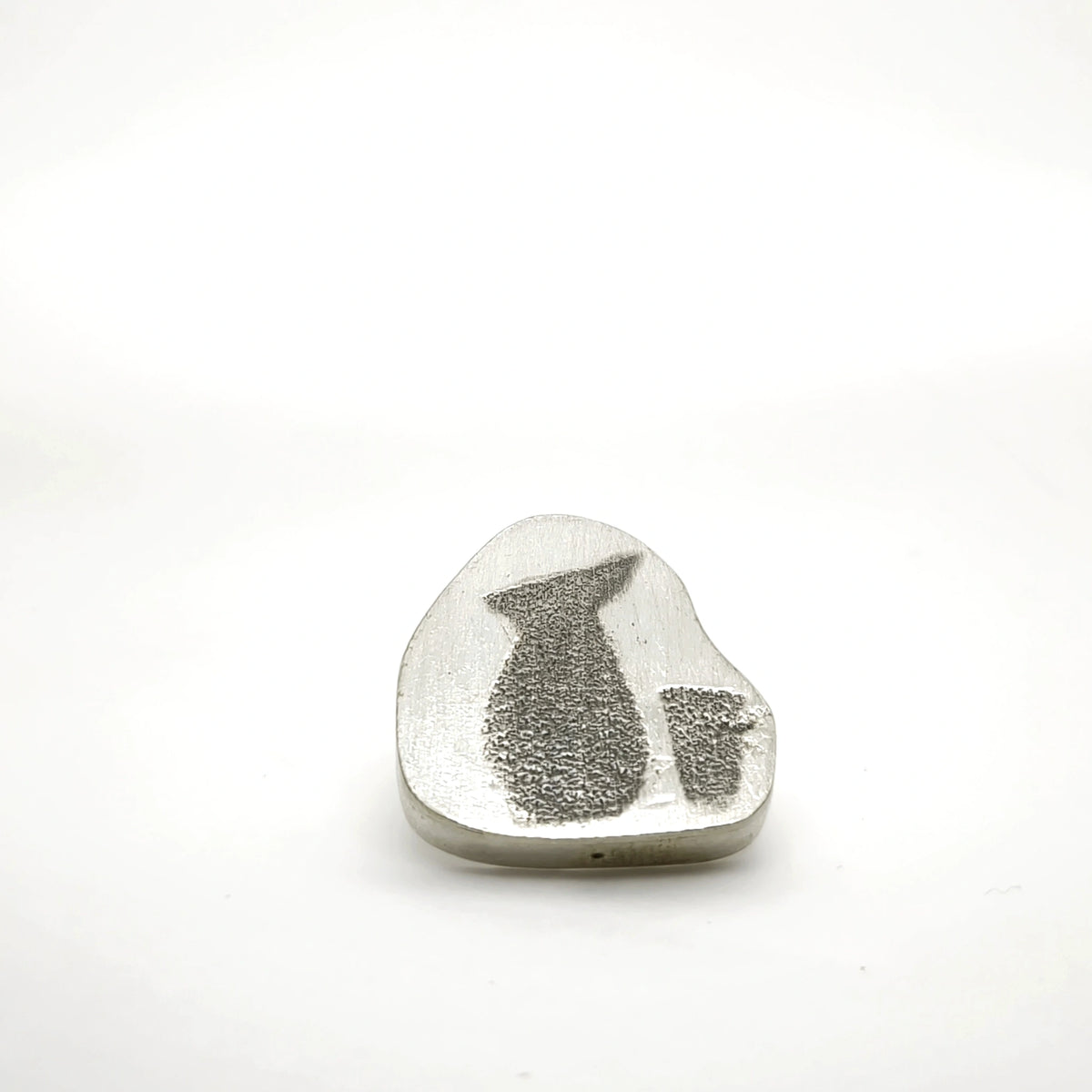Sterling silver pin featuring a jug and glass motif, front view.