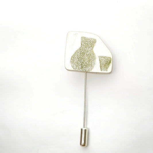 Sterling silver pin featuring a green jug and glass motif, front view.