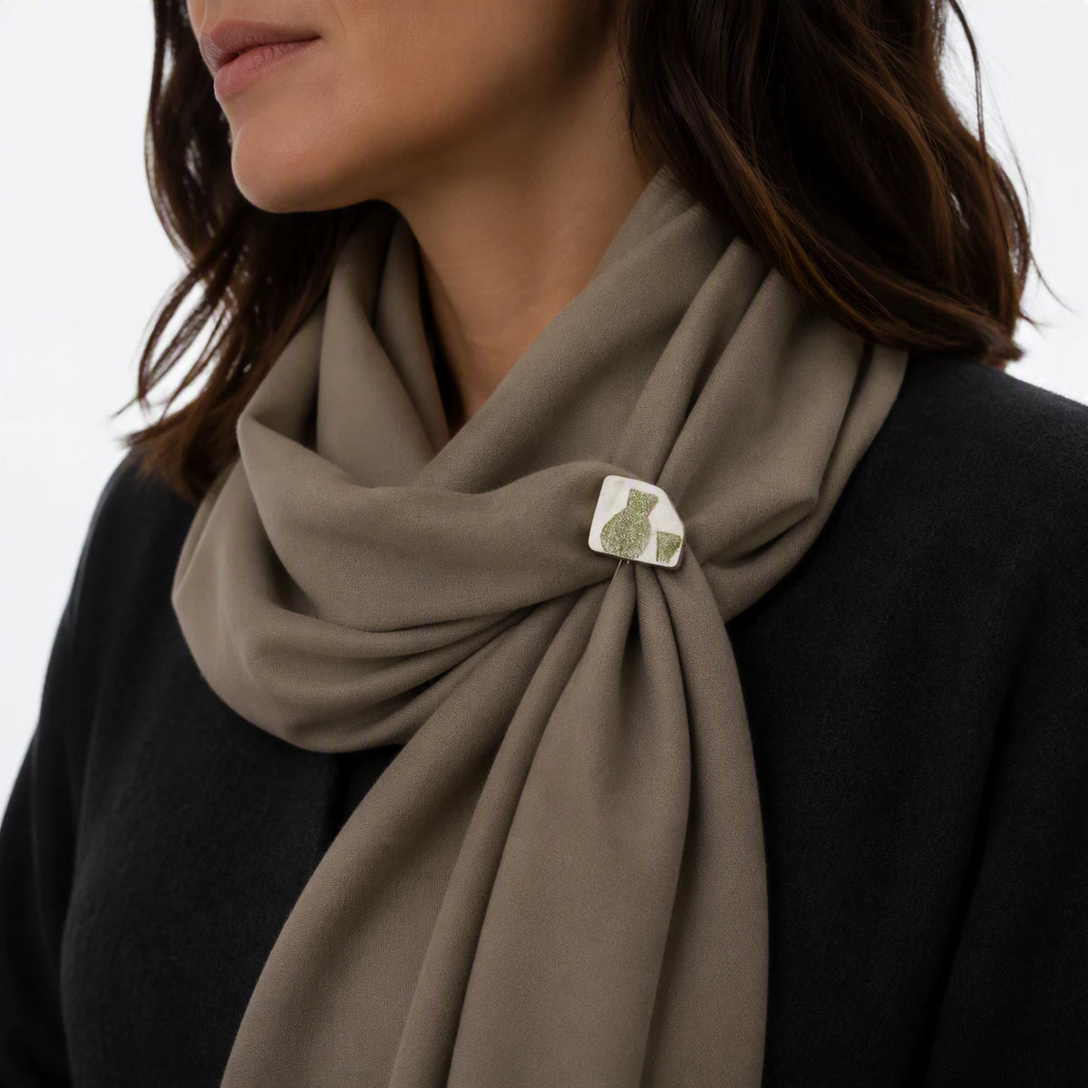Sterling silver pin with a green jug and glass motif securing a soft taupe scarf, from the At the Table collection.