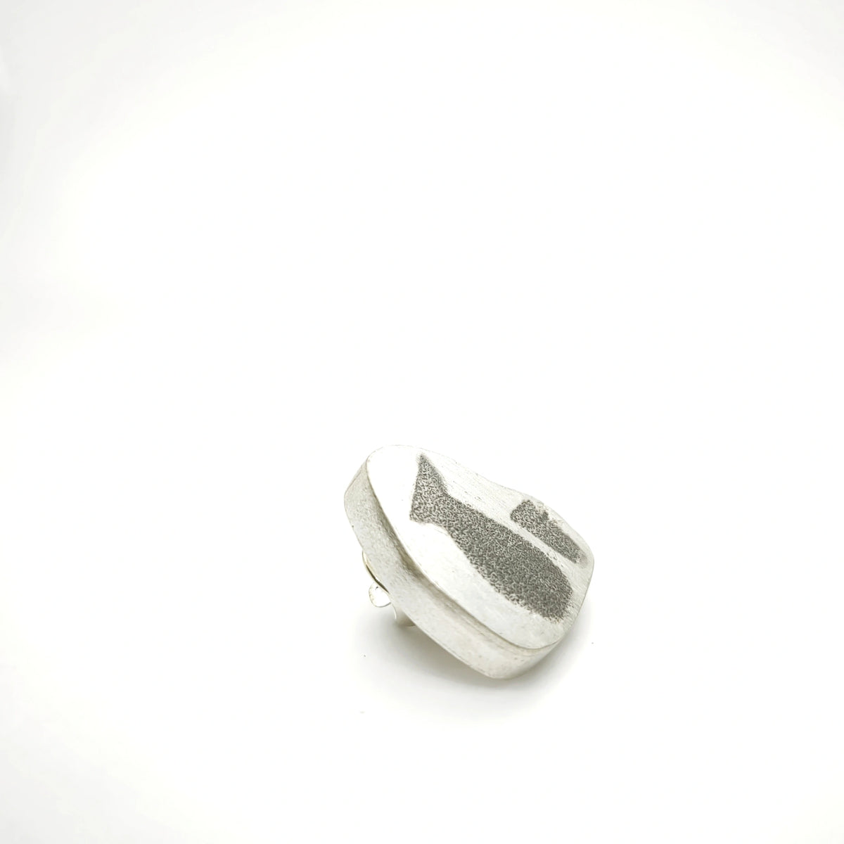 Side view of a sterling silver pin featuring a jug and glass