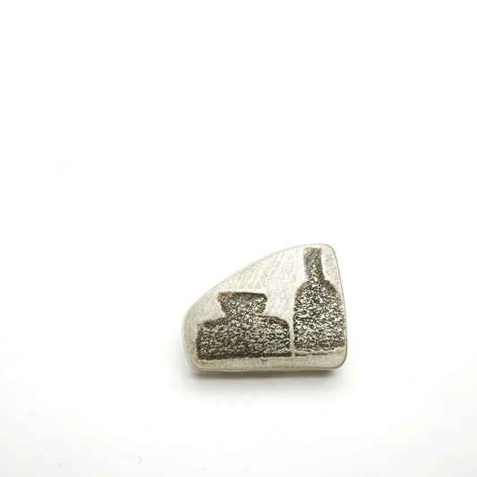 Sterling silver pin featuring two bottle motifs, front view.