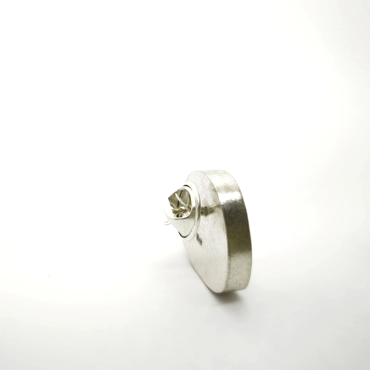 Reverse side of a sterling silver pin showing the fastening mechanism.