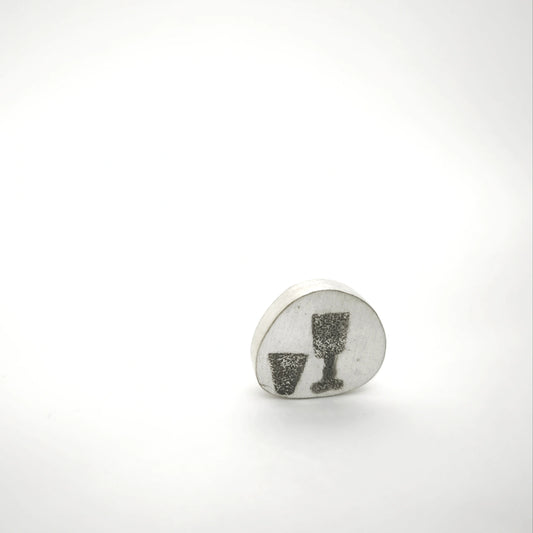 Sterling silver pin featuring two glass motifs, front view.