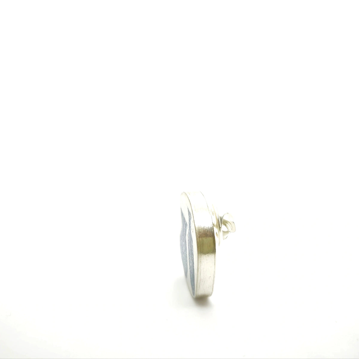 Detail of the hallmark and reverse side of a sterling silver pin from the At the Table collection.
Show more lines
